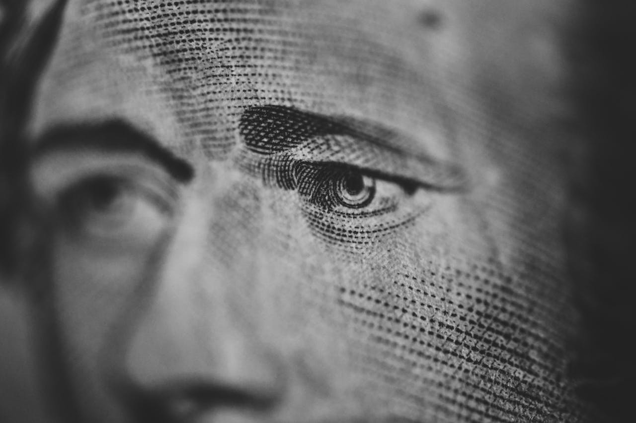 Extreme close-up of an engraved eye on a paper currency note, highlighting intricate details.